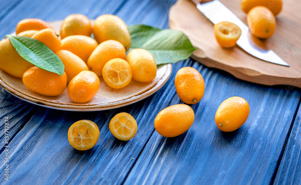 kumquat on plate at wooden table