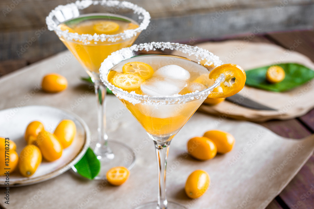 cocktail with kumquat on wooden background