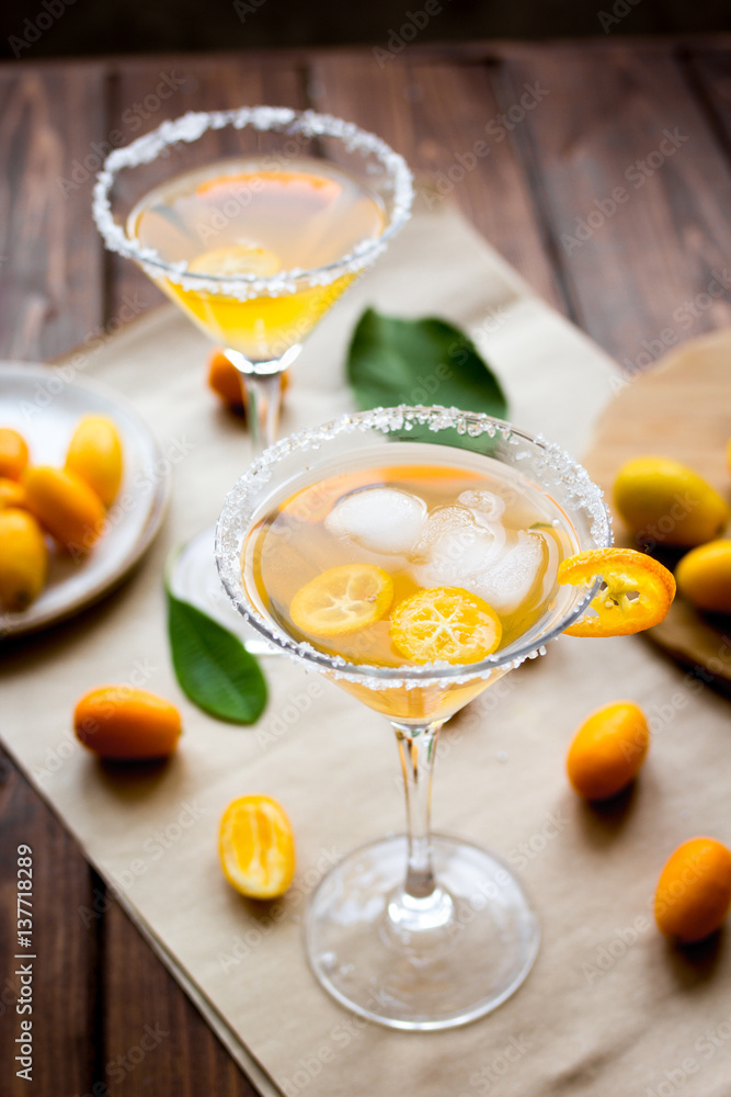 cocktail with kumquat on wooden background