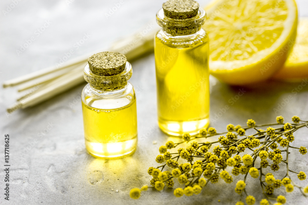 Natural cosmetic with bath salt and organic oil on gray background