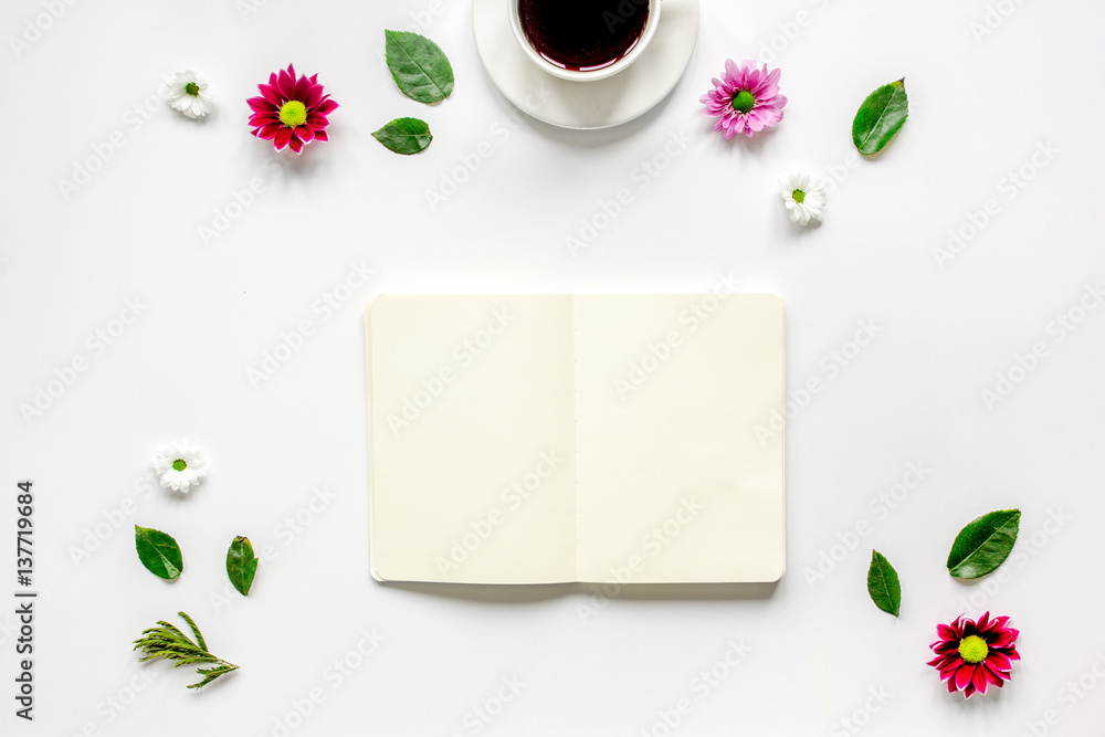 Copybook, americano and flowers on white table top view mock-up