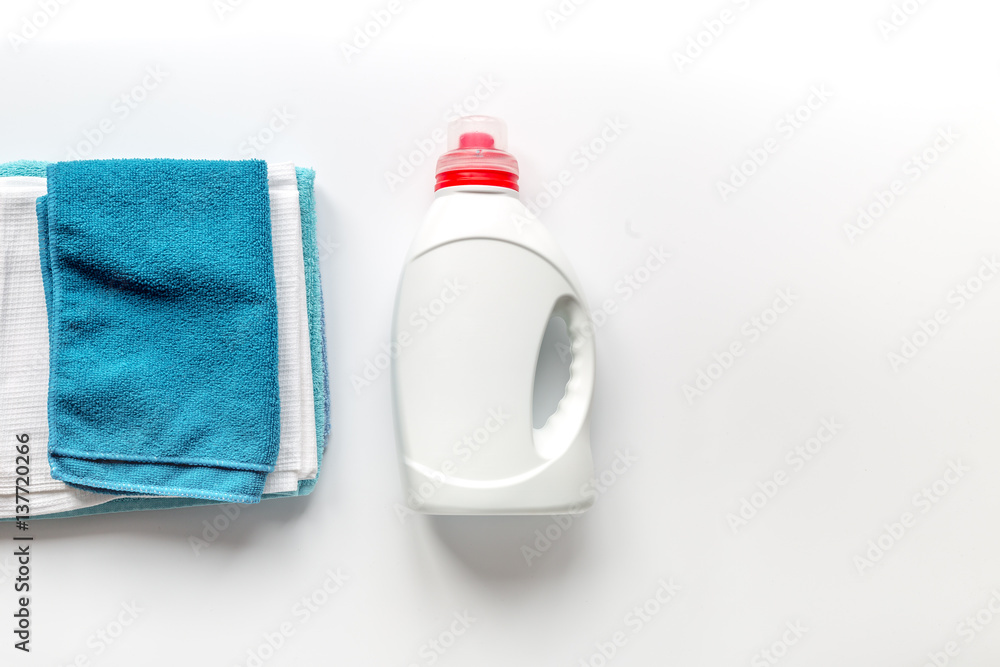 housekeeping set with towels and plastic bottles in laundry top view mock up