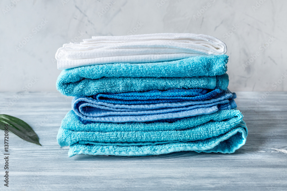 Towels pile in housekeeping set on laudry background mock-up