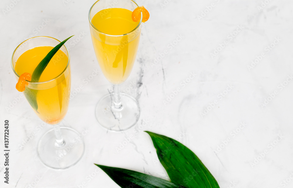 cocktail with physalis in glass on stone background