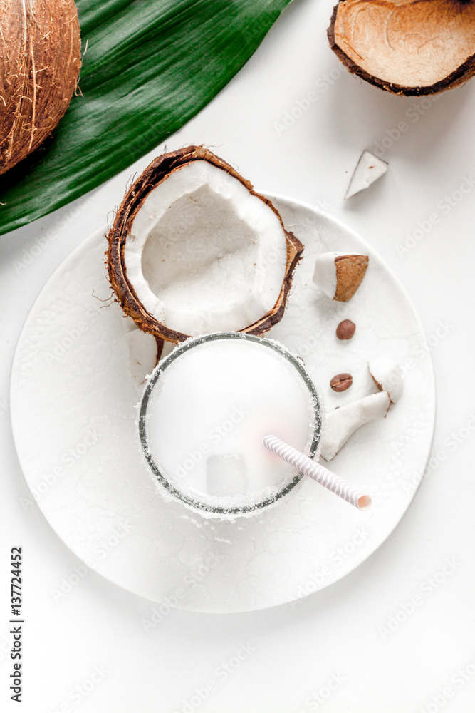 cocktail with coconut on white background top view