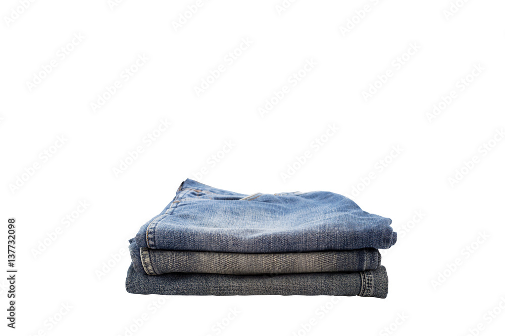 pile of clothes,stack of blue jeans isolated on white background.