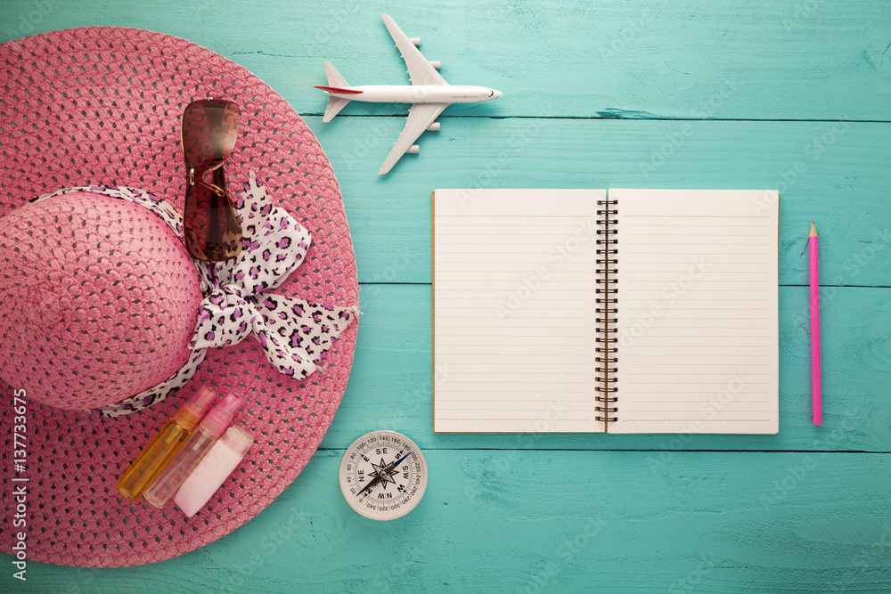 White paper blank page with different beach accessories on wood surface. Summer background.