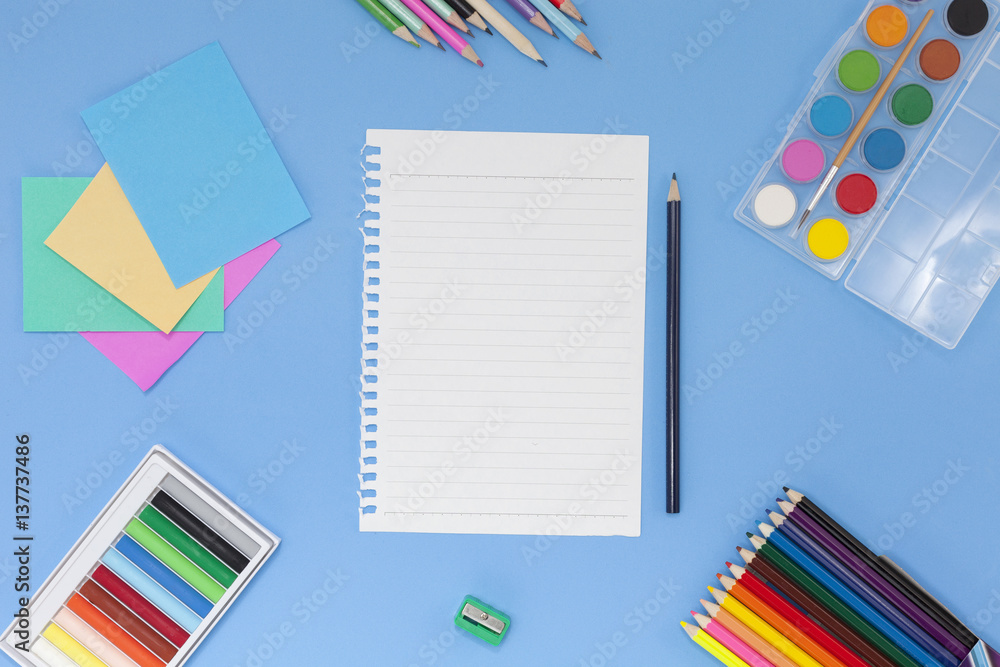 School supplies on blue background,back to school concept.