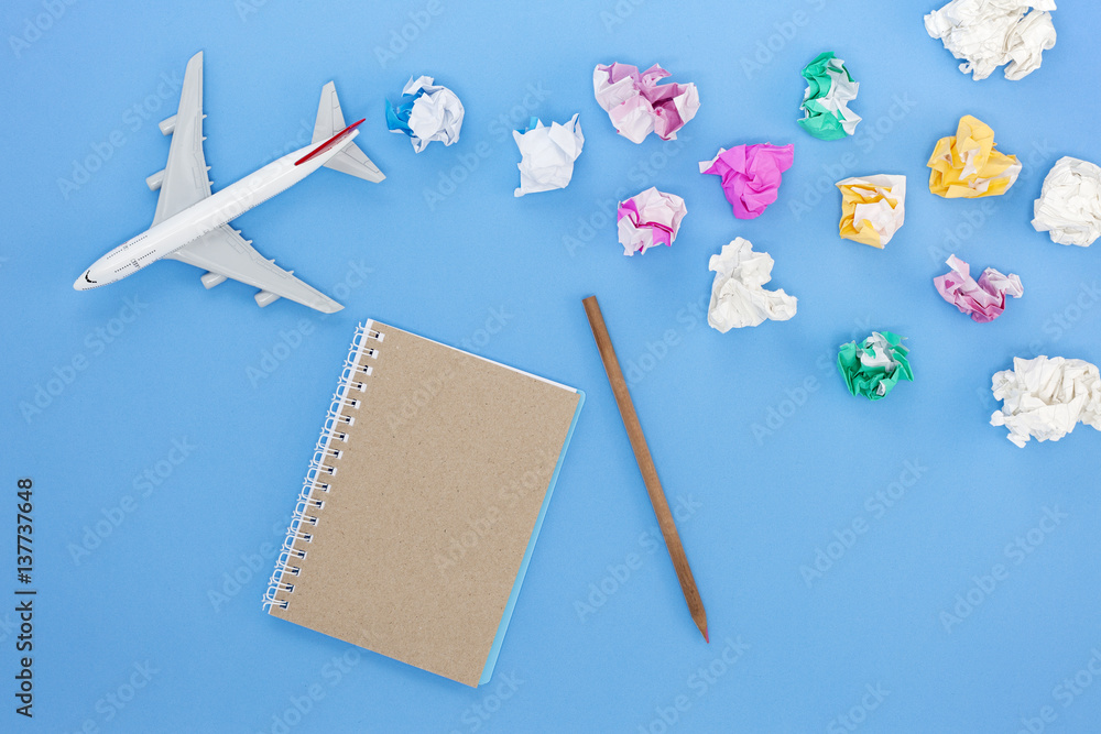 Airplane model with colorful blank paper note on blue background, picture for add text message or us