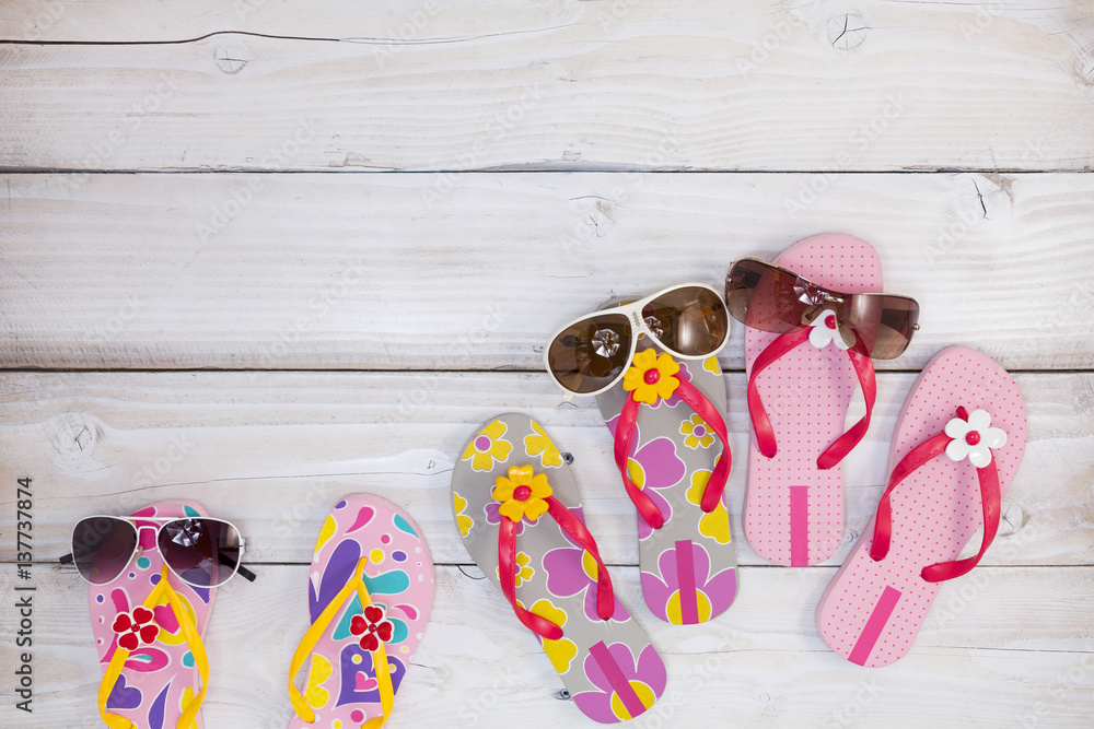 beach shoes with sunglasses on white wood background,Summer holiday concept.