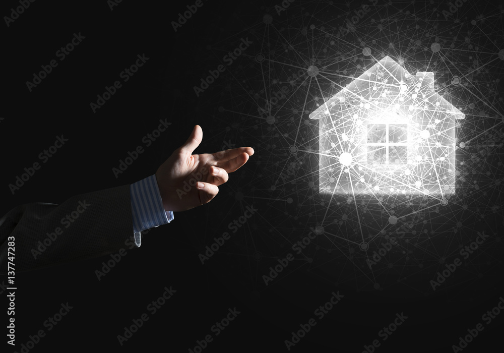 Conceptual image with hand pointing at house or main page icon on dark background