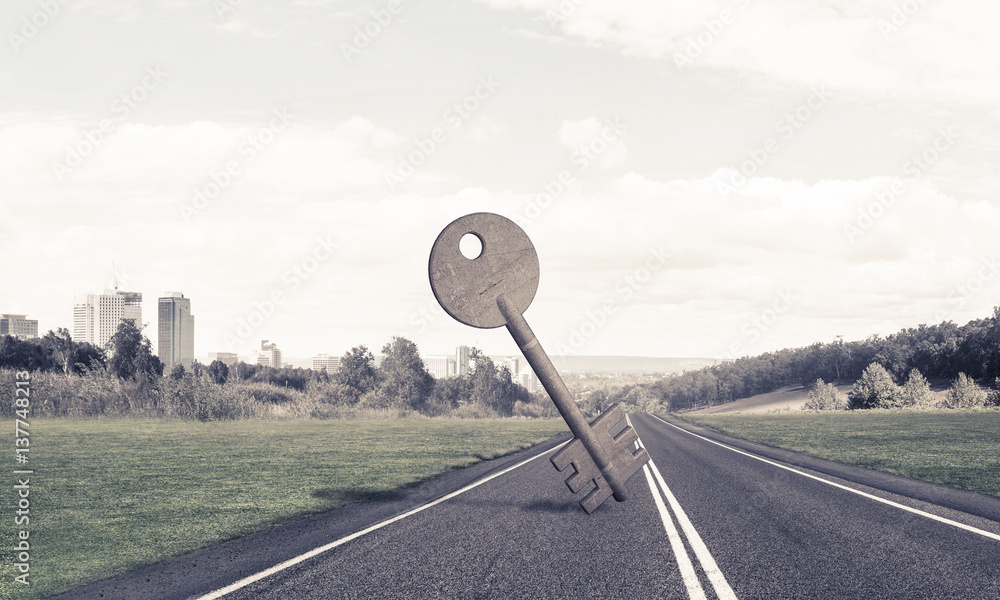 Conceptual background image of concrete key sign on asphalt road