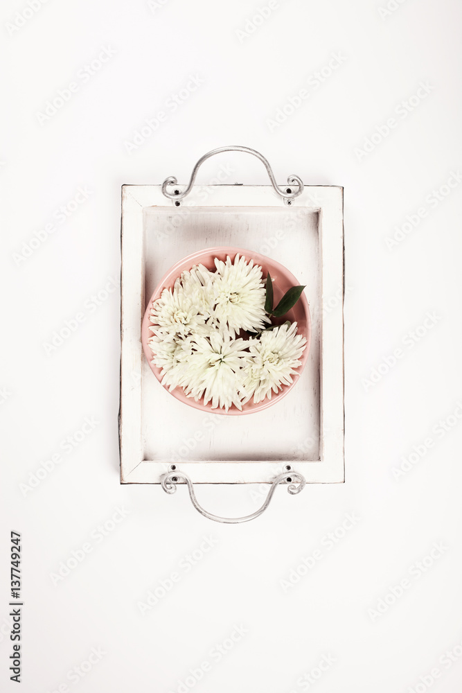 Close up of flowers floating in bowl of water