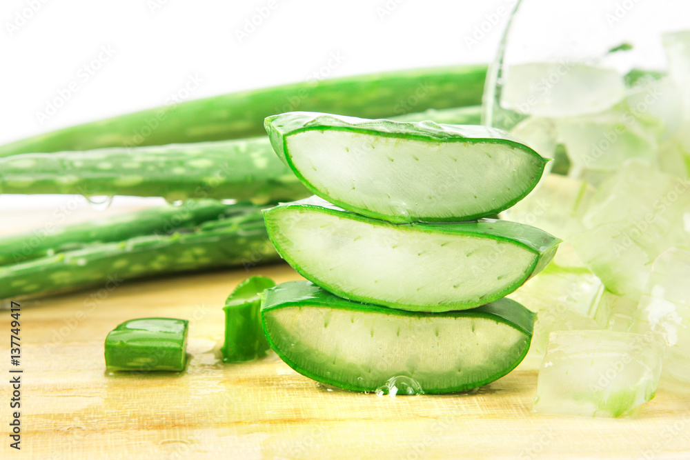 the sliced and leaf of fresh aloe vera on  wooden plate , natural clear gel as the star beauty ingre