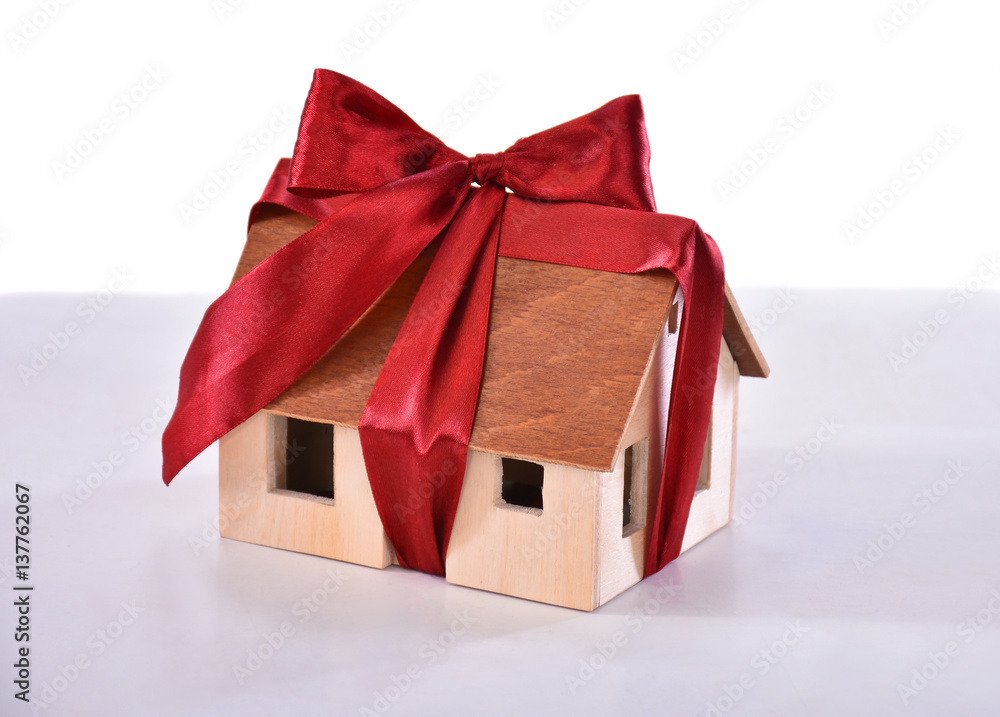 Small model of a wooden house tied with a bow