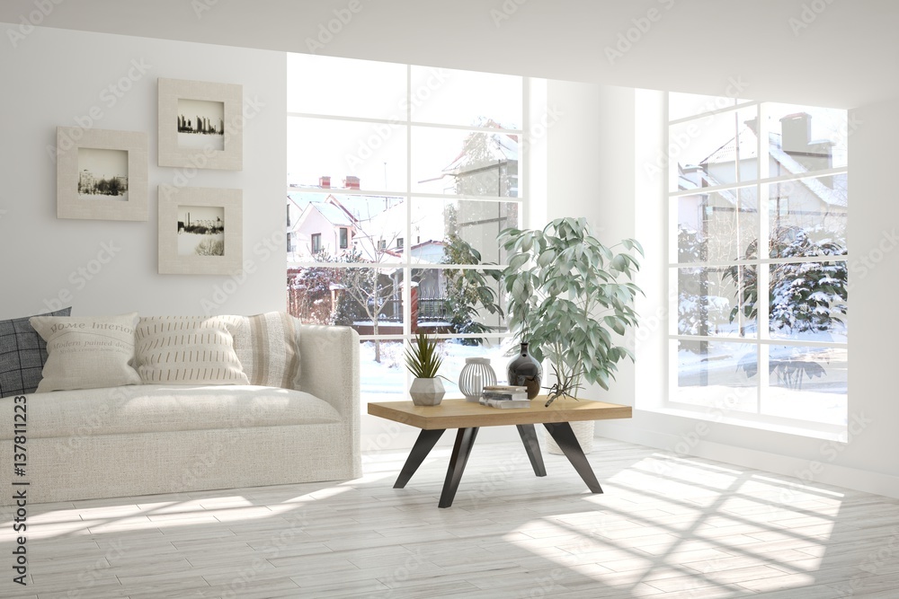 White room with sofa and winter landscape in window. Scandinavian interior design