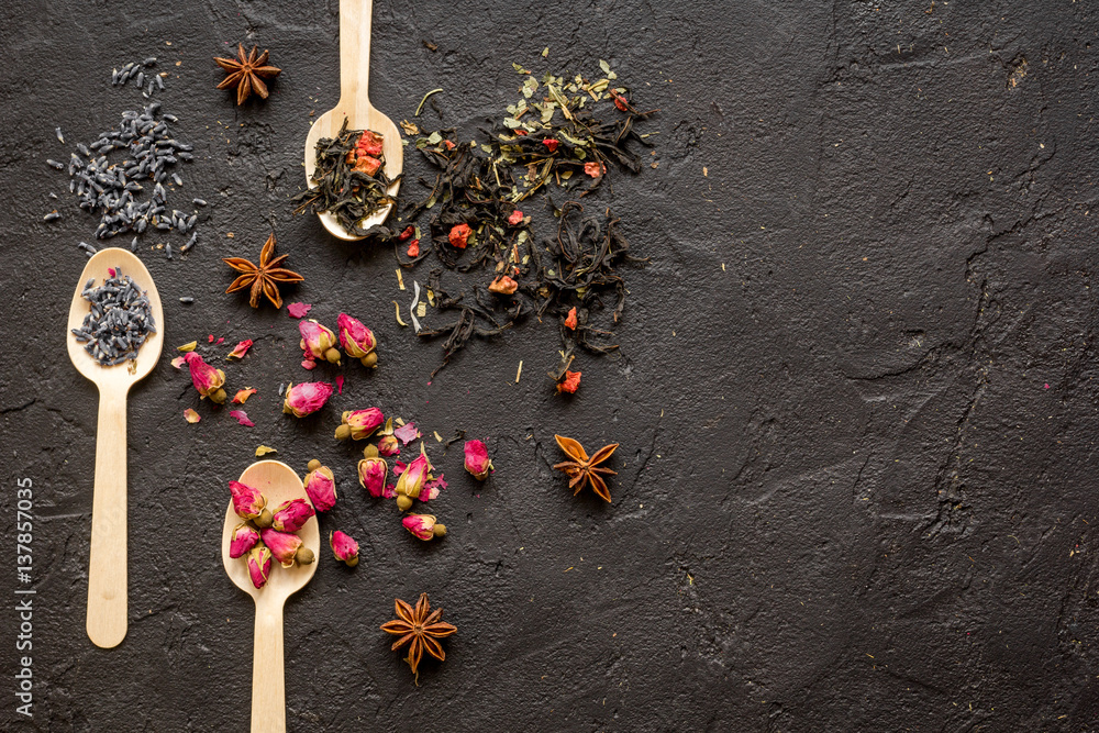 Herbs on spoons black background mock-up top view