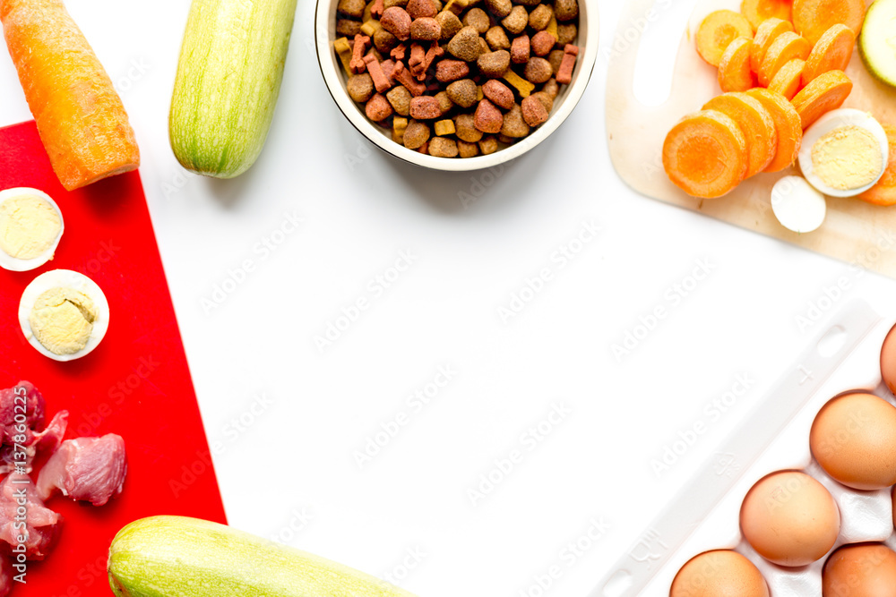 Food for pets with eggs and vegetables on kitchen top view mock-up