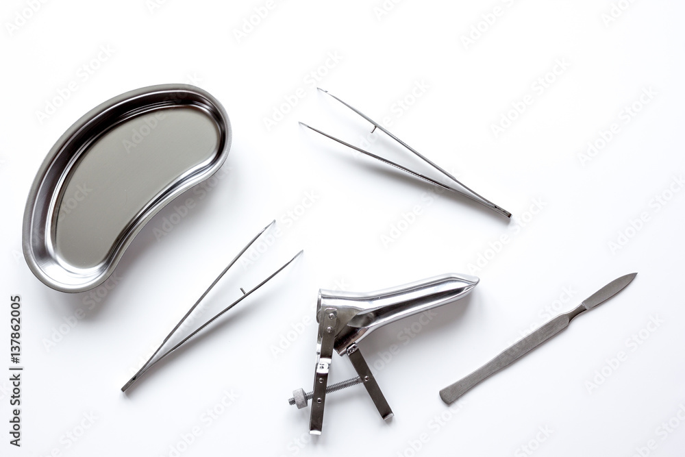 instruments of gynecologist on white background top view