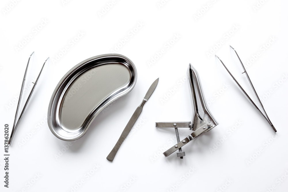 instruments of gynecologist on white background top view