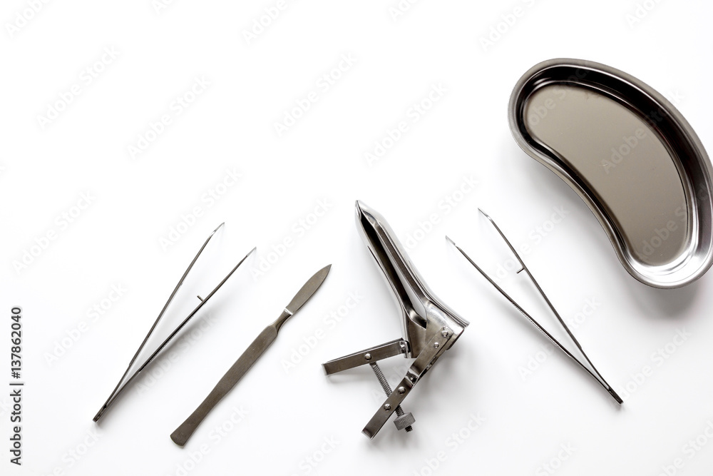 instruments of gynecologist on white background top view