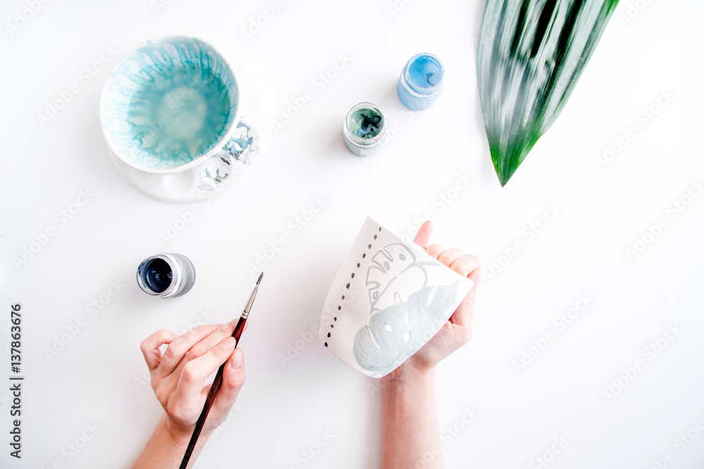 painted ceramic cup on white background top view