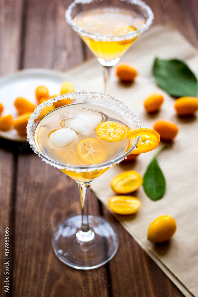 cocktail with kumquat on wooden background