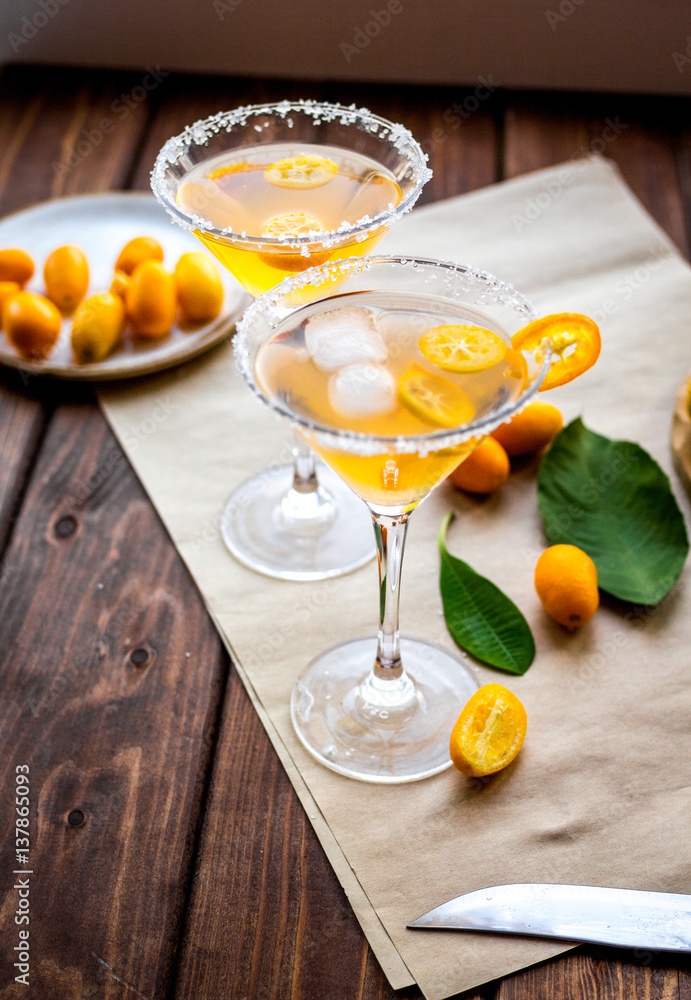 cocktail with kumquat on wooden background