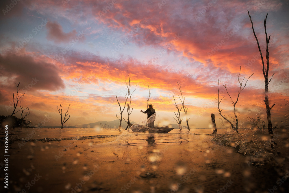 Fisherman working with net on the boat