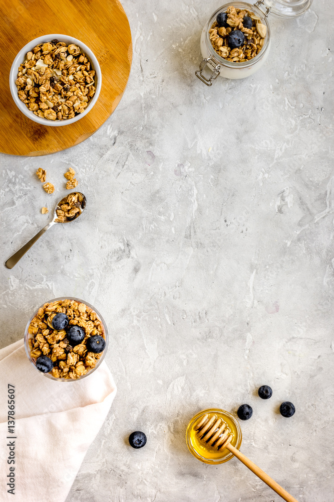 Oat flakes and berries granola glass on table background top view