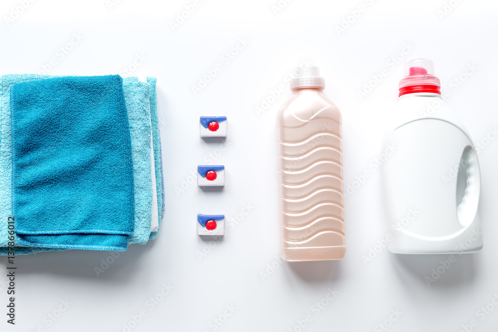 housekeeping set with towels and plastic bottles in laundry top view