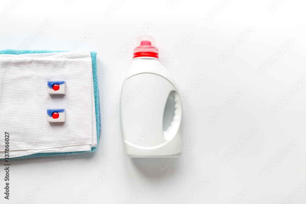 laundry set with towels and plastic bottels on white background top view mock-up