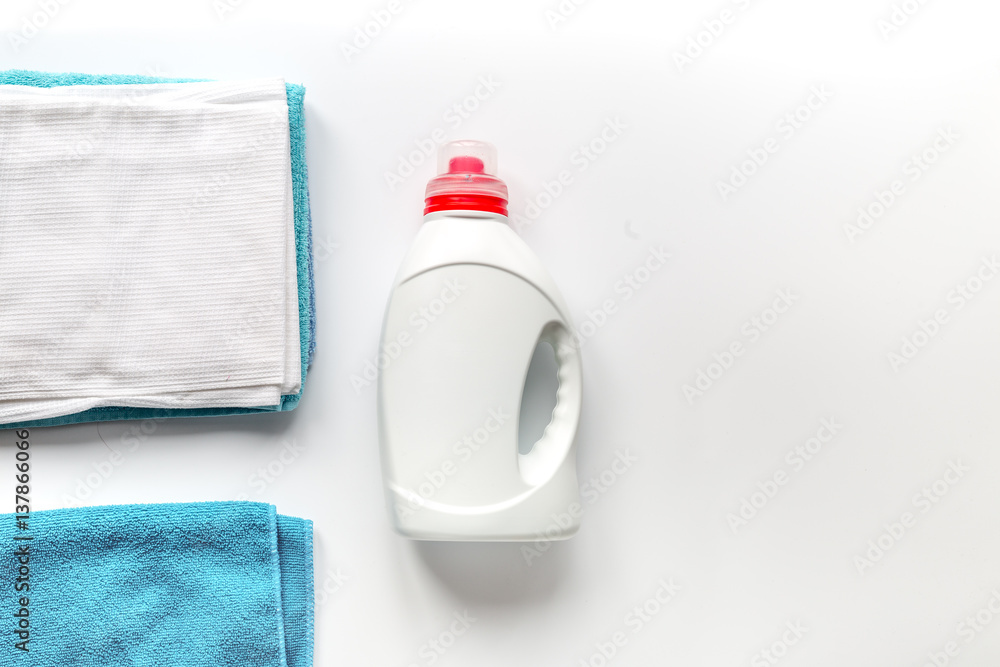 housekeeping set with towels and plastic bottles in laundry top view mockup