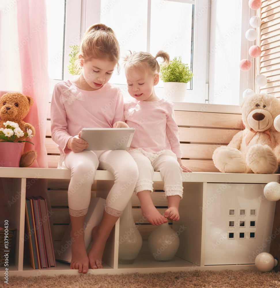 children are playing with tablet