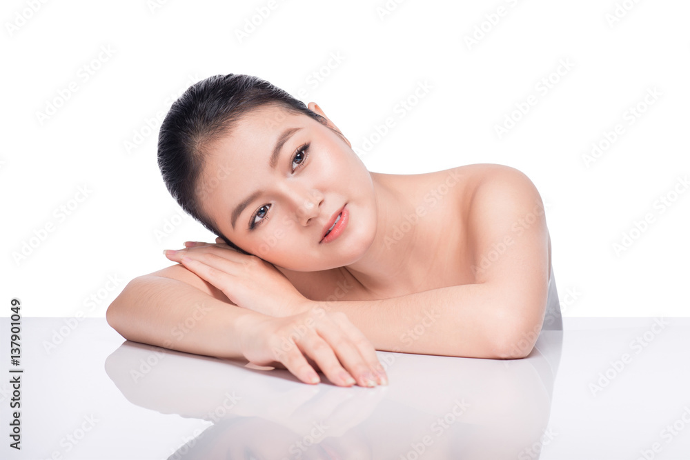 Facial treatment. Beautiful Young Asian Woman with Clean Fresh Skin touch her face