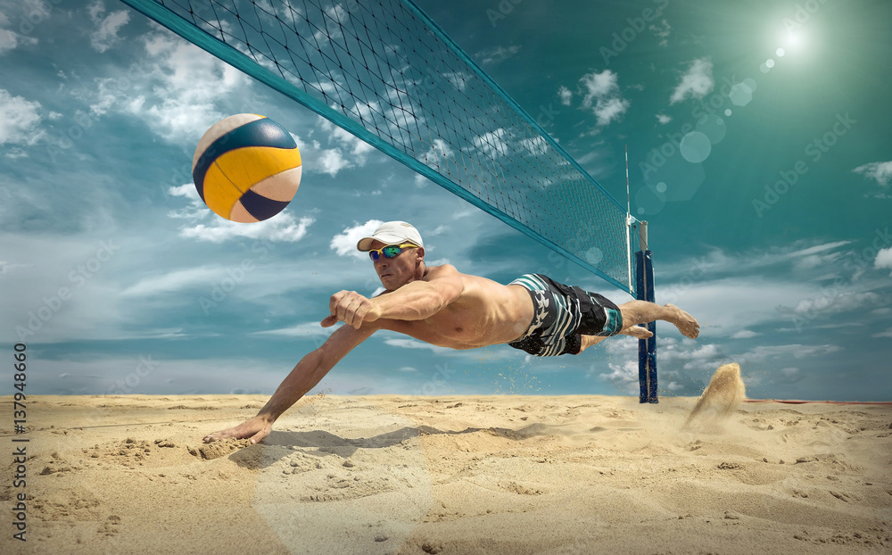 Beach volleyball player in action at sunny day under blue sky.