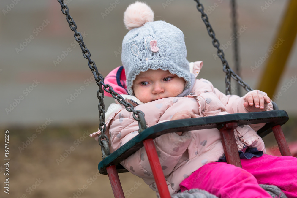 Little girl having fun on the swing