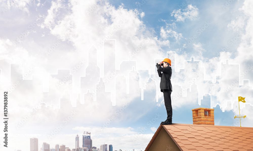 Engineer man standing on roof and looking in binoculars. Mixed media