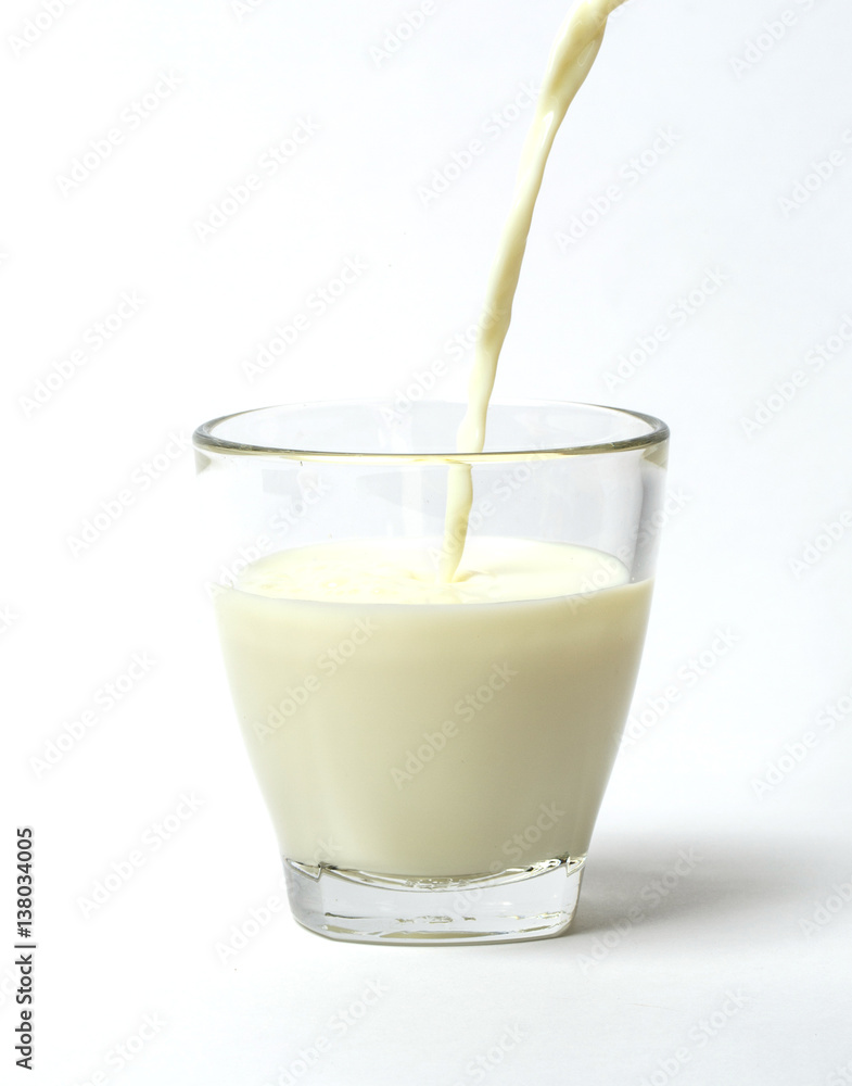 Pouring a cup of milk creating splash