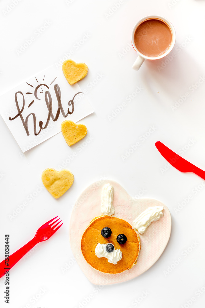 concept kid breakfast with pancake top view on white background