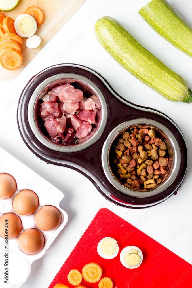 petfood set with vegetables and eggs on kitchen table background top view