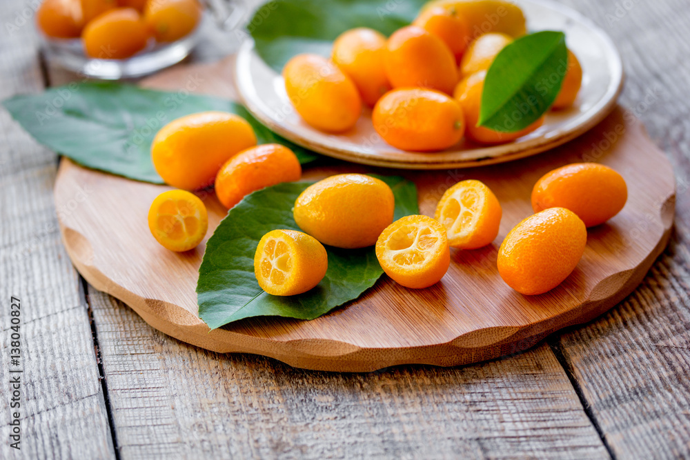 kumquat on plate at wooden table