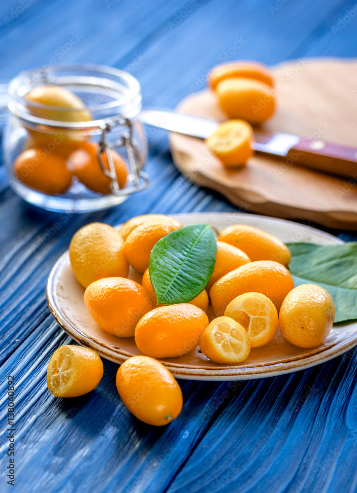 kumquat on plate at wooden table