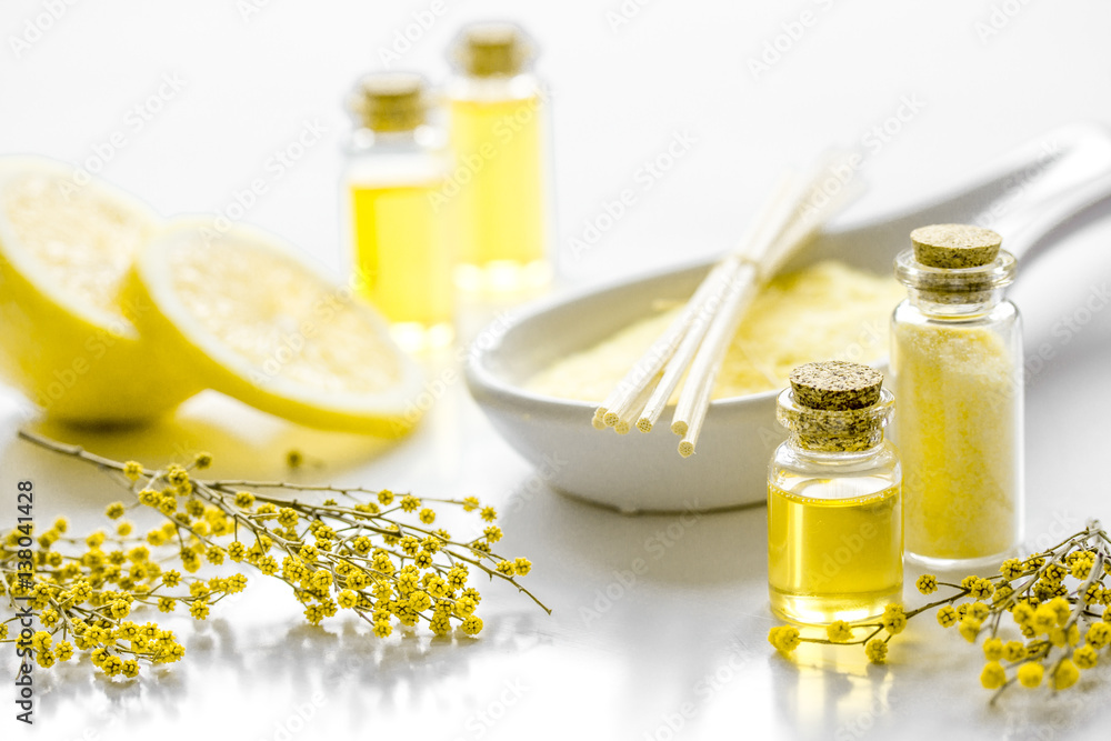 Home cosmetic with essential oil and sea salt on white background