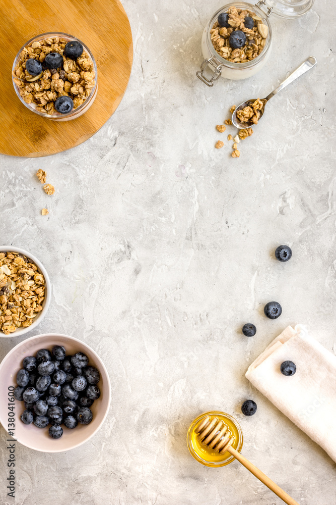 Oat flakes and berries granola glass on table background top view