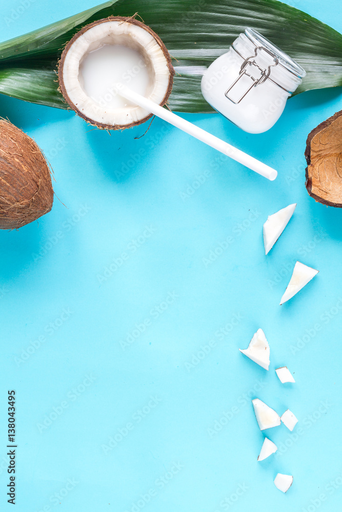 concept organic cosmetics with coconut on blue background top view