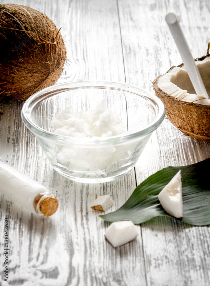 organic cosmetics with coconut on wooden background close up