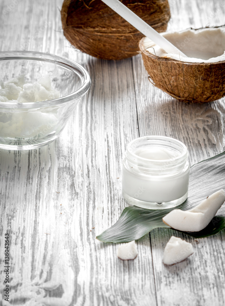 organic cosmetics with coconut on wooden background close up