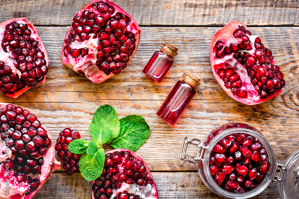 sliced pomegranate on wooden background top view