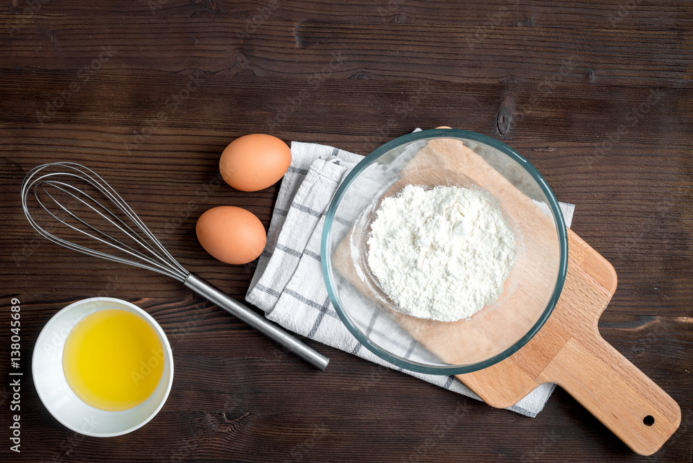 cooking pancake on wooden background top view ingredients for making